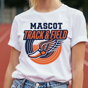 May include: White t-shirt with the text "MASCOT TRACK & FIELD" in navy blue and orange. The shirt features a graphic of a winged running shoe inside a navy blue and orange circle. The person is wearing blue denim shorts.