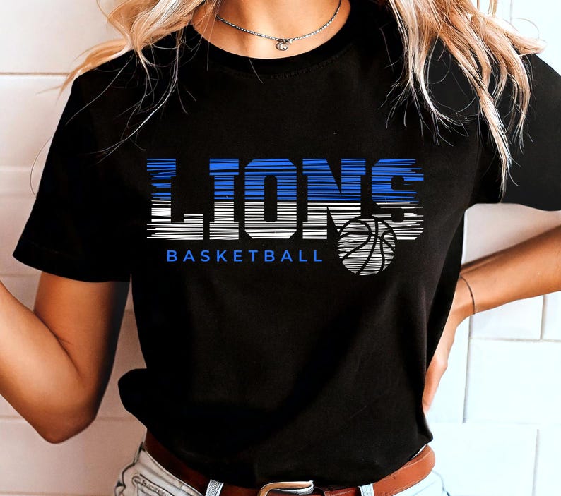 May include: Black t-shirt with a blue and white graphic that says "LIONS BASKETBALL" with a basketball graphic.