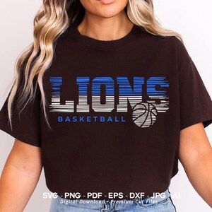 May include: A black t-shirt with a blue and white graphic design that says "LIONS BASKETBALL" with a basketball graphic.