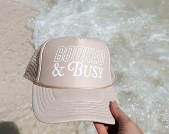 Booked and Busy Trucker Hat, Travel, Vacation Hat, Baseball Season, Baseball Mom, Busy Mom, Otto Premium foam Trucker Hat