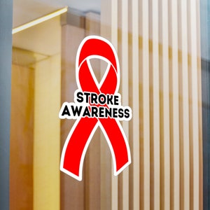 May include: Red ribbon with the text "STROKE AWARENESS" in black letters. The ribbon is a symbol of awareness for stroke.