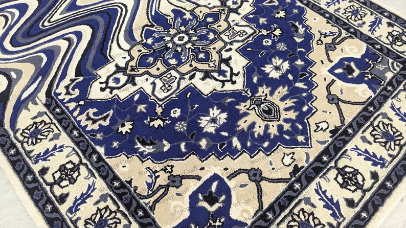 May include: Close-up of a patterned rug with a traditional design. The rug features a combination of blue, cream, and gray colors. The design includes floral and geometric patterns, creating a detailed and ornate appearance.