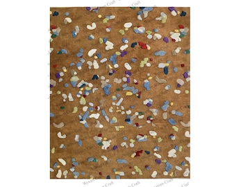 May include: A brown rug with a colorful abstract pattern of various shapes and sizes. The rug is made of woven fabric and has a textured surface.