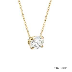 May include: A delicate gold chain necklace with a single round diamond pendant.
