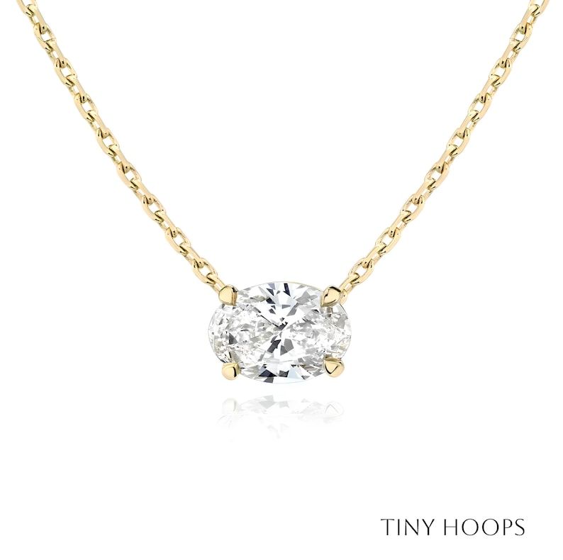 May include: A gold chain necklace with a large oval-shaped diamond pendant.