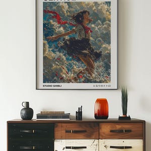 May include: A poster for the Studio Ghibli film Kiki's Delivery Service. The poster features a young woman with red hair flying through the air with a red scarf trailing behind her. The text on the poster reads "Kiki's Delivery Service" and "Studio Ghibli".