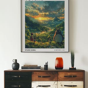 May include: A poster featuring a scene from the animated film My Neighbor Totoro. The poster features a sunset over a lush green valley with a large, furry creature called Totoro in the foreground. The text "My Neighbor Totoro" and "Studio Ghibli" are printed on the poster.