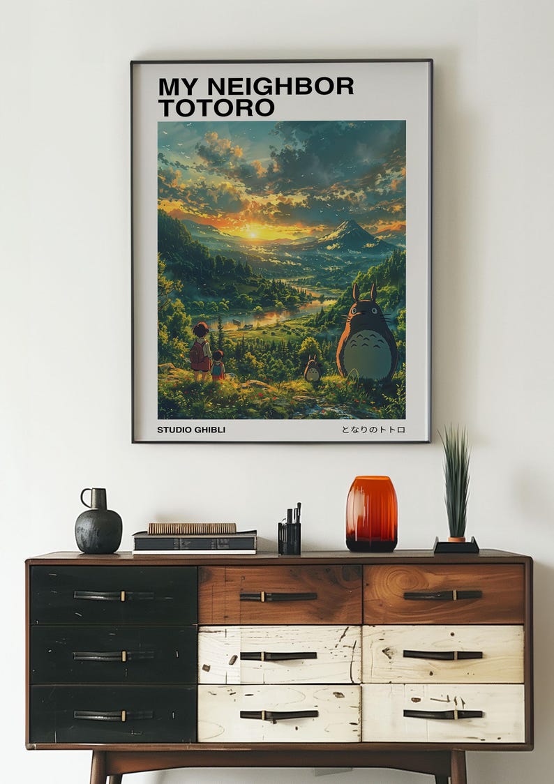 May include: A poster featuring a scene from the animated film My Neighbor Totoro. The poster features a sunset over a lush green valley with a large, furry creature called Totoro in the foreground. The text "My Neighbor Totoro" and "Studio Ghibli" are printed on the poster.