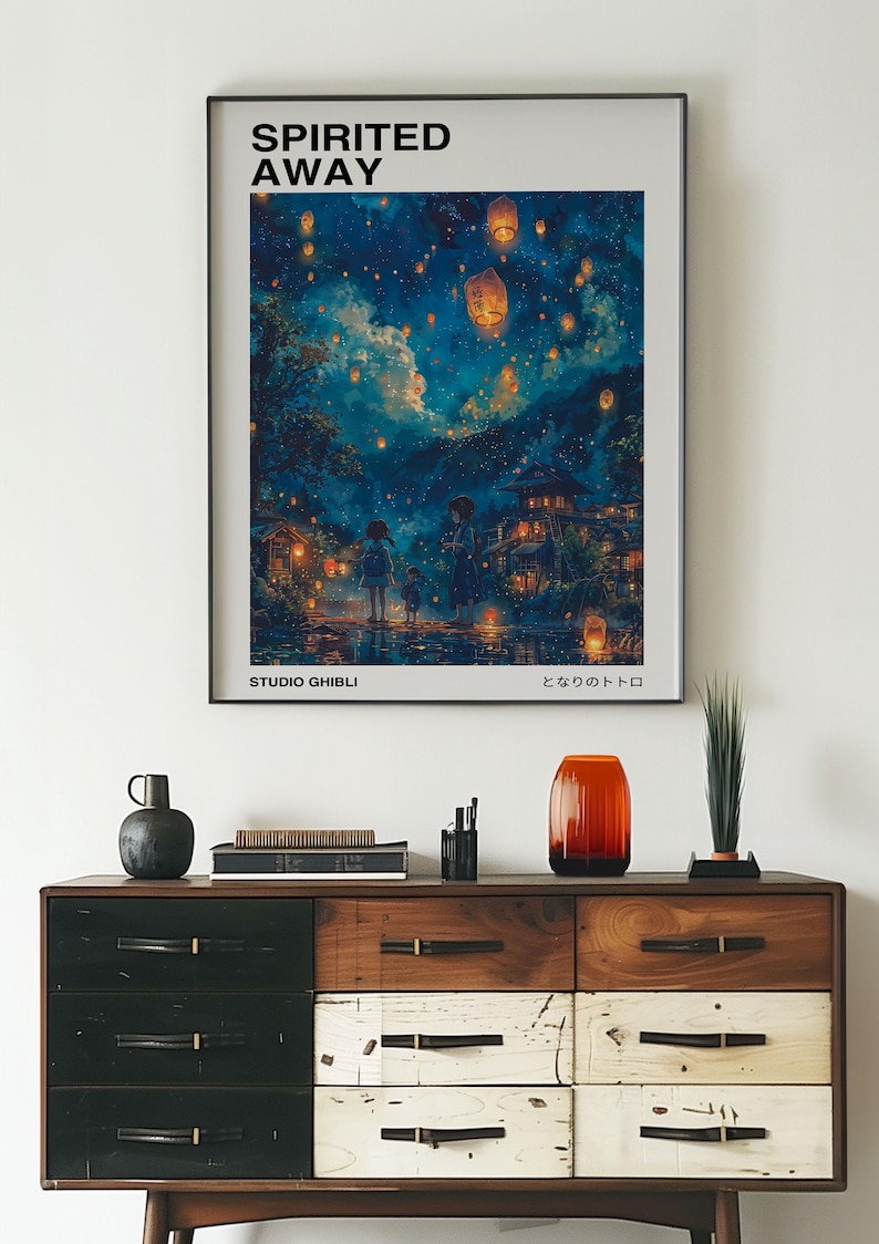 May include: A framed poster with a blue and purple night sky filled with glowing lanterns. The poster features the title "Spirited Away" and the text "Studio Ghibli" and "となりのトトロ".