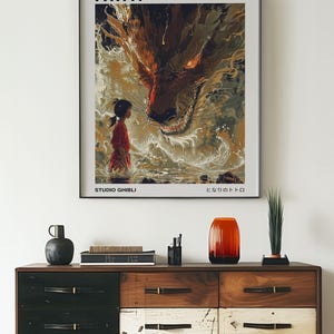 May include: A poster for the Studio Ghibli film "Spirited Away" featuring a young girl standing in front of a large, red dragon-like creature. The text "Spirited Away" and "Studio Ghibli" are visible at the top and bottom of the poster, respectively. The Japanese text "となりのトトロ" is also visible at the bottom of the poster.