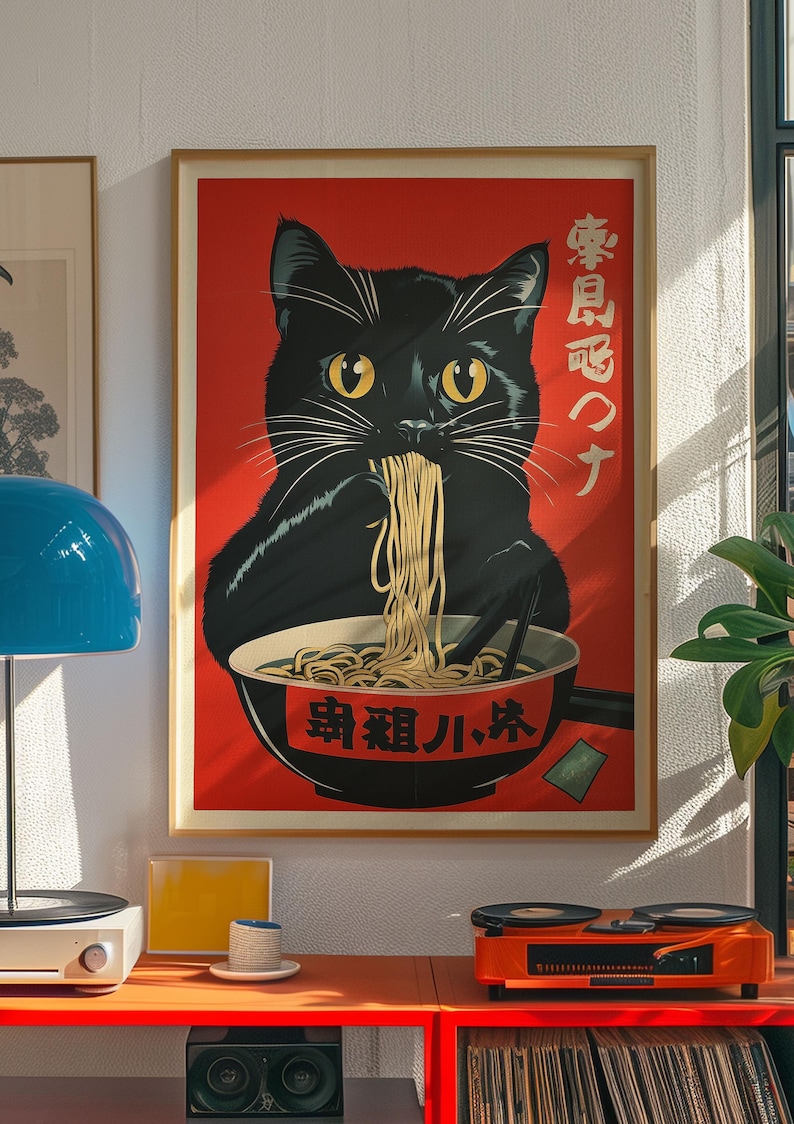 May include: A framed poster featuring a black cat eating ramen from a bowl. The cat has yellow eyes and white whiskers. The background is red with Japanese text. The poster is in a wooden frame.