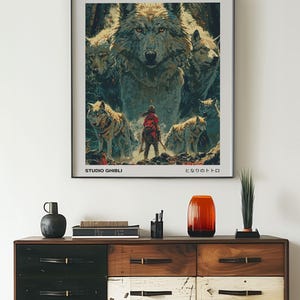 May include: A vintage-style poster for the Studio Ghibli film "Princess Mononoke" featuring a wolf and a young woman in a red outfit. The poster has the Japanese title "もののけ姫" and the text "Studio Ghibli" at the bottom.