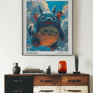 May include: A poster featuring a cartoon image of Totoro, a large, furry, blue creature from the Studio Ghibli film "My Neighbor Totoro". The poster has the title "My Neighbor Totoro" and the Japanese title "となりのトトロ" at the bottom.