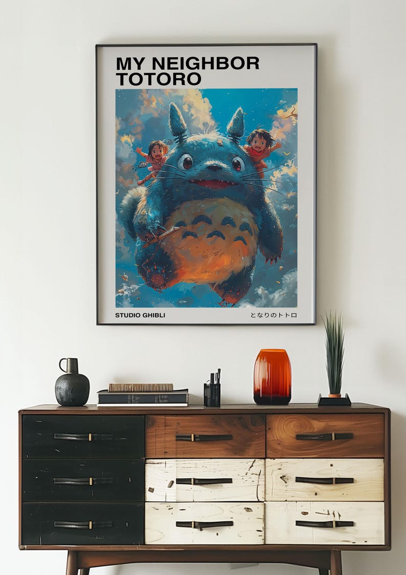 May include: A poster featuring a cartoon image of Totoro, a large, furry, blue creature from the Studio Ghibli film "My Neighbor Totoro". The poster has the title "My Neighbor Totoro" and the Japanese title "となりのトトロ" at the bottom.