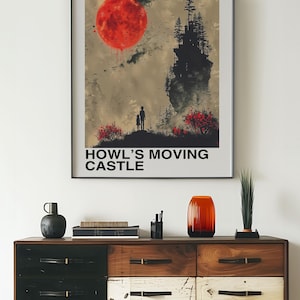 May include: Framed poster featuring a scene from "Howl's Moving Castle" with a large red sun, a silhouette of a castle, and the text "HOWL'S MOVING CASTLE". The poster is displayed above a wooden dresser with various decorative items.