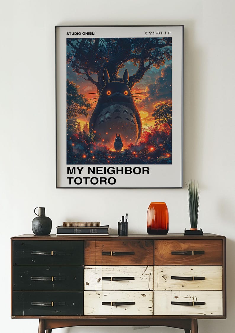 May include: A poster featuring a large, furry, grey creature with glowing eyes, standing in a forest at sunset. The creature is surrounded by fireflies. The poster is titled "My Neighbor Totoro" and includes the text "Studio Ghibli" and "となりのトトロ".