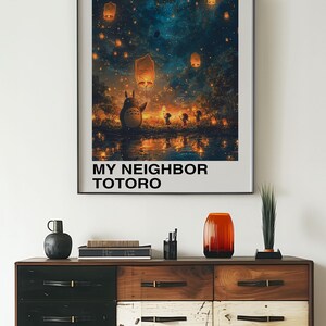 May include: A poster featuring a scene from the Studio Ghibli film "My Neighbor Totoro". The poster depicts Totoro, a large, furry creature, standing in a forest with a group of children. The sky is filled with glowing lanterns and stars. The poster is titled "My Neighbor Totoro" and features the Japanese text "となりのトトロ" which translates to "My Neighbor Totoro".