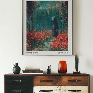 May include: A black framed poster with the title "Spirited Away" in white text. The poster features a still from the animated film, depicting a young girl with a white mask standing in a field of red flowers. The poster also includes the text "Studio Ghibli" and "となりのトトロ" in Japanese.
