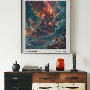 May include: Framed poster featuring the text "HOWL'S MOVING CASTLE" above a vibrant, colorful illustration of a fantastical landscape. The poster includes the text "STUDIO GHIBLI" and Japanese text. The poster is displayed above a wooden dresser.