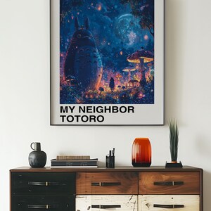 May include: A poster featuring a blue and purple illustration of Totoro, a large, furry creature from the Studio Ghibli film "My Neighbor Totoro". The poster has the title "My Neighbor Totoro" and the Japanese text "となりのトトロ" in white text on a black background.