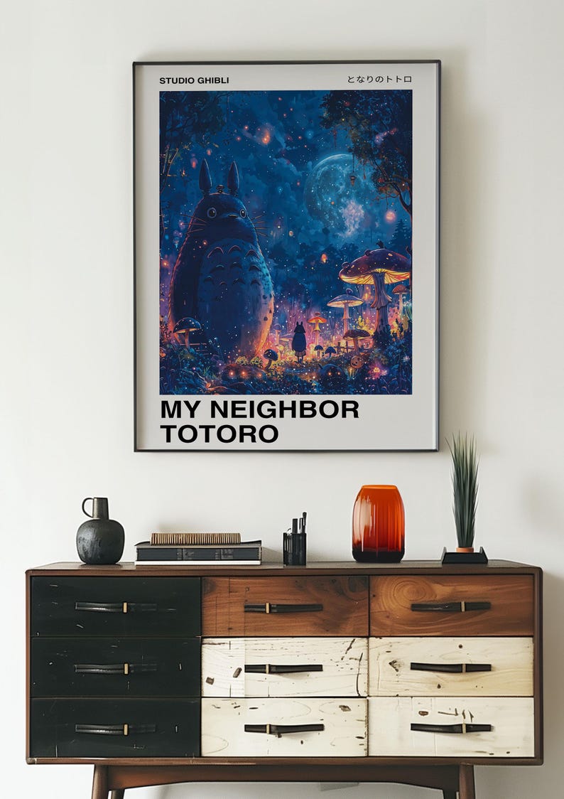 May include: A poster featuring a blue and purple illustration of Totoro, a large, furry creature from the Studio Ghibli film "My Neighbor Totoro". The poster has the title "My Neighbor Totoro" and the Japanese text "となりのトトロ" in white text on a black background.