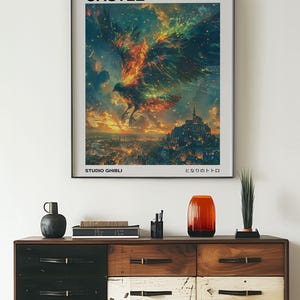 May include: A framed poster with the text "HOWL'S MOVING CASTLE" and a vibrant illustration of a fiery bird soaring over a city. The poster is above a wooden dresser with various decorative items.