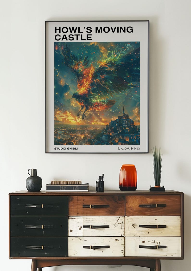 May include: A framed poster with the text "HOWL'S MOVING CASTLE" and a vibrant illustration of a fiery bird soaring over a city. The poster is above a wooden dresser with various decorative items.