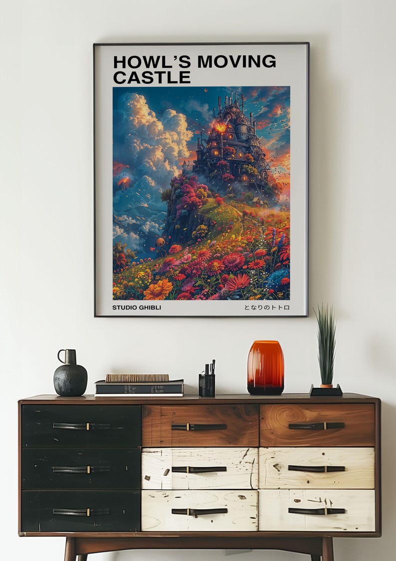 May include: A framed poster featuring the animated film "Howl's Moving Castle." The artwork depicts a fantastical castle amidst colorful flowers and a vibrant sky. The poster includes the text "HOWL'S MOVING CASTLE" and "STUDIO GHIBLI."