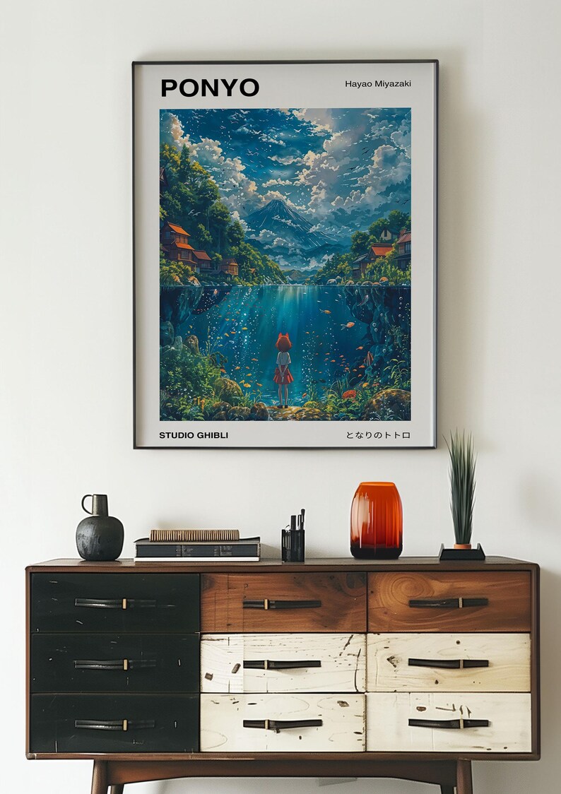 May include: A poster for the Studio Ghibli film "Ponyo" by Hayao Miyazaki. The poster features a young girl standing on a rock in the water, looking out at a beautiful landscape. The text on the poster reads "Ponyo", "Studio Ghibli", "Hayao Miyazaki", and "となりのトトロ".