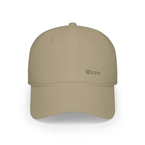 May include: A beige baseball cap with a dark green embroidered logo that says "Micro".