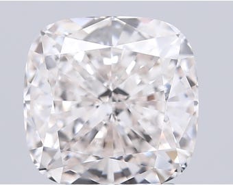 May include: A close-up of a cushion-cut diamond. The diamond is clear and colorless, with many facets that reflect light. The shape is square with rounded corners, and the facets create a brilliant sparkle.