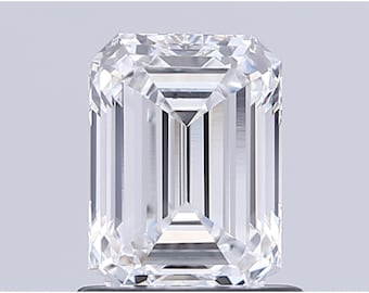 May include: A clear, emerald-cut diamond with a rectangular shape. The facets reflect light, creating a brilliant sparkle. The gemstone is set against a neutral background, highlighting its clarity and cut.