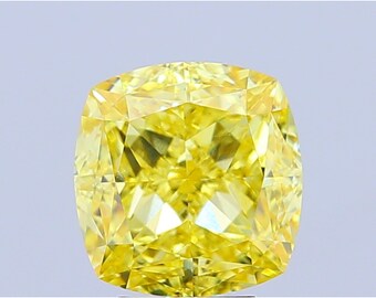 May include: A cushion-cut, fancy vivid yellow diamond. The gemstone has a square shape with rounded corners and numerous facets, reflecting light. The diamond's color is a vibrant, intense yellow, and it is set against a light background.