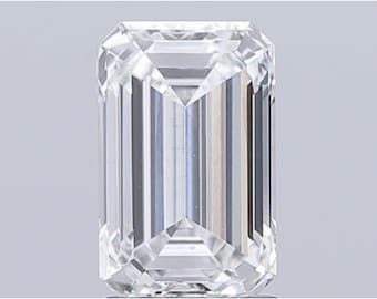 May include: A clear, emerald-cut diamond with a rectangular shape. The facets reflect light, creating a brilliant sparkle. The diamond is set against a neutral background, highlighting its clarity and cut.
