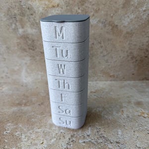 May include: A set of three ceramic mugs with a speckled, matte finish in cream, light grey, and dark grey. Each mug has a simple, minimalist design, ideal for coffee or tea.