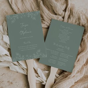 May include: Two sage green wedding fans with wooden handles. The fans feature floral designs and text, including names and the date "October 19, 20XX." One fan lists the order of service, and the other includes a thank you message.