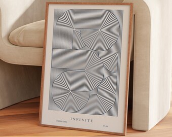 May include: A framed abstract print with a geometric design of overlapping blue and white lines. The print is titled "INFINITE" and is displayed on a beige armchair in a modern living room.