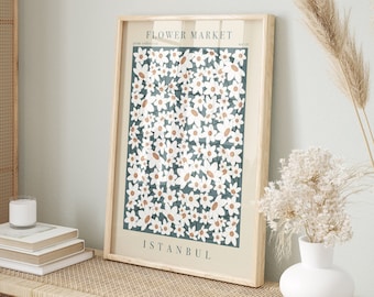 May include: A framed print with a floral design. The print features white flowers on a teal background. The text "FLOWER MARKET" and "ISTANBUL" are printed on the print.