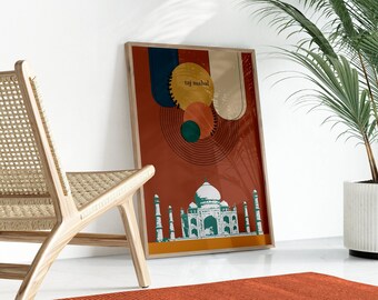 May include: A framed art print featuring the Taj Mahal. The artwork has a red background with abstract shapes in blue, beige, and orange. The Taj Mahal is depicted in green and white. The words "taj mahal" are printed on the artwork.