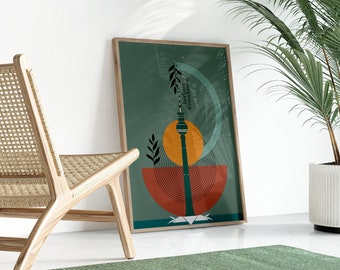 May include: A framed print with a green background and a stylized illustration of the Berlin Fernsehturm, a television tower in Berlin, Germany. The tower is surrounded by geometric shapes in shades of orange, red, and brown.
