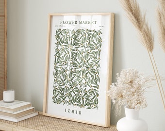 May include: A framed print with a white background and a green olive branch pattern. The print has the text "FLOWER MARKET" and "IZMIR" in black.
