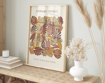 May include: A framed print with a nature-inspired design featuring a collection of leaves in shades of brown, green, and orange. The print is titled "Nature Spirit Leaf Collection".