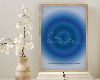 May include: A framed print with a blue gradient background and a white outline of a person in a yoga pose. The text "I am wise, intuitive, and connected to my inner guidance." is at the bottom of the print.