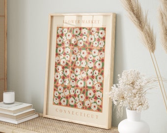 May include: A framed print with a floral pattern in shades of white, red, and green on a peach background. The print reads "FLOWER MARKET CONNECTICUT".