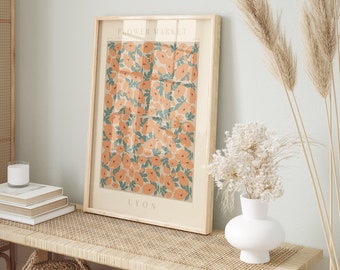 May include: A framed print with a floral pattern in shades of orange and green. The print has the text "FLOWER MARKET LYON" at the top and bottom.