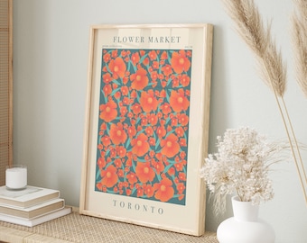May include: A framed print with a floral design in shades of orange and teal. The print features the text "FLOWER MARKET" and "TORONTO".