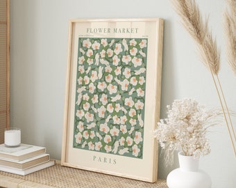 May include: A framed print with a green background and white flowers. The print says "FLOWER MARKET" and "PARIS" at the top and bottom, respectively.