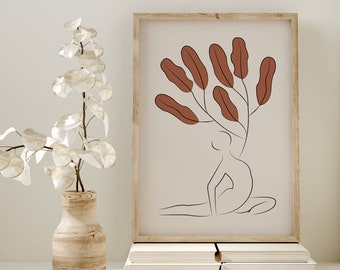 May include: A framed print with a minimalist line drawing of a person sitting with a cluster of brown leaves above their head. The print is on a white background and is framed in a light wood frame.