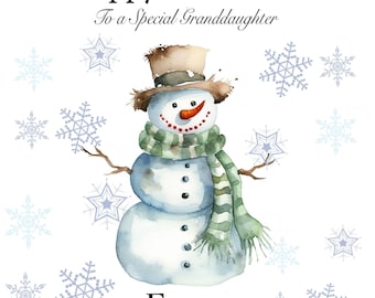 May include: A watercolor illustration of a snowman wearing a green and white striped scarf and a brown hat. The snowman has a carrot nose and red buttons. The background is white with blue snowflakes. The text "Happy Christmas" and "To a special granddaughter" is at the top of the image. The name "FREYA" is at the bottom of the image.
