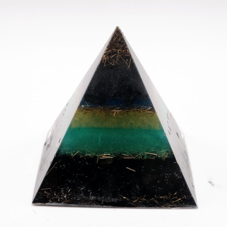 May include: A layered pyramid-shaped object with a black base, transitioning to green, yellow, and blue layers, topped with a dark apex. The layers are interspersed with gold-colored metallic inclusions, creating a unique aesthetic.